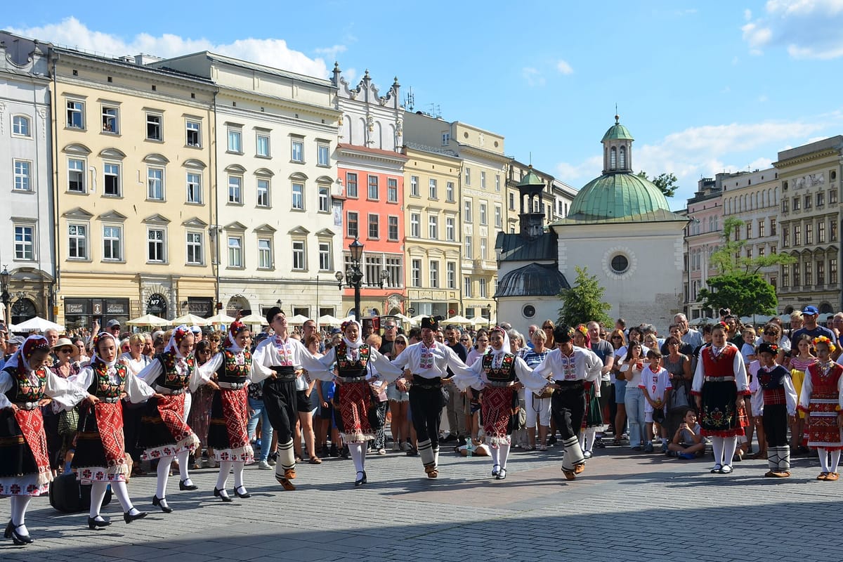 Folk dancers performing on Kraków's Main Market Square in summer