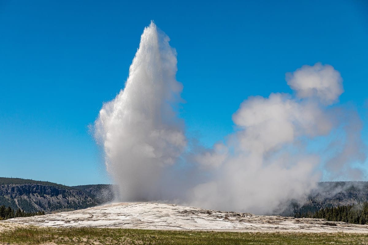 Old Faithful geyser erupting in Yellowstone National Park