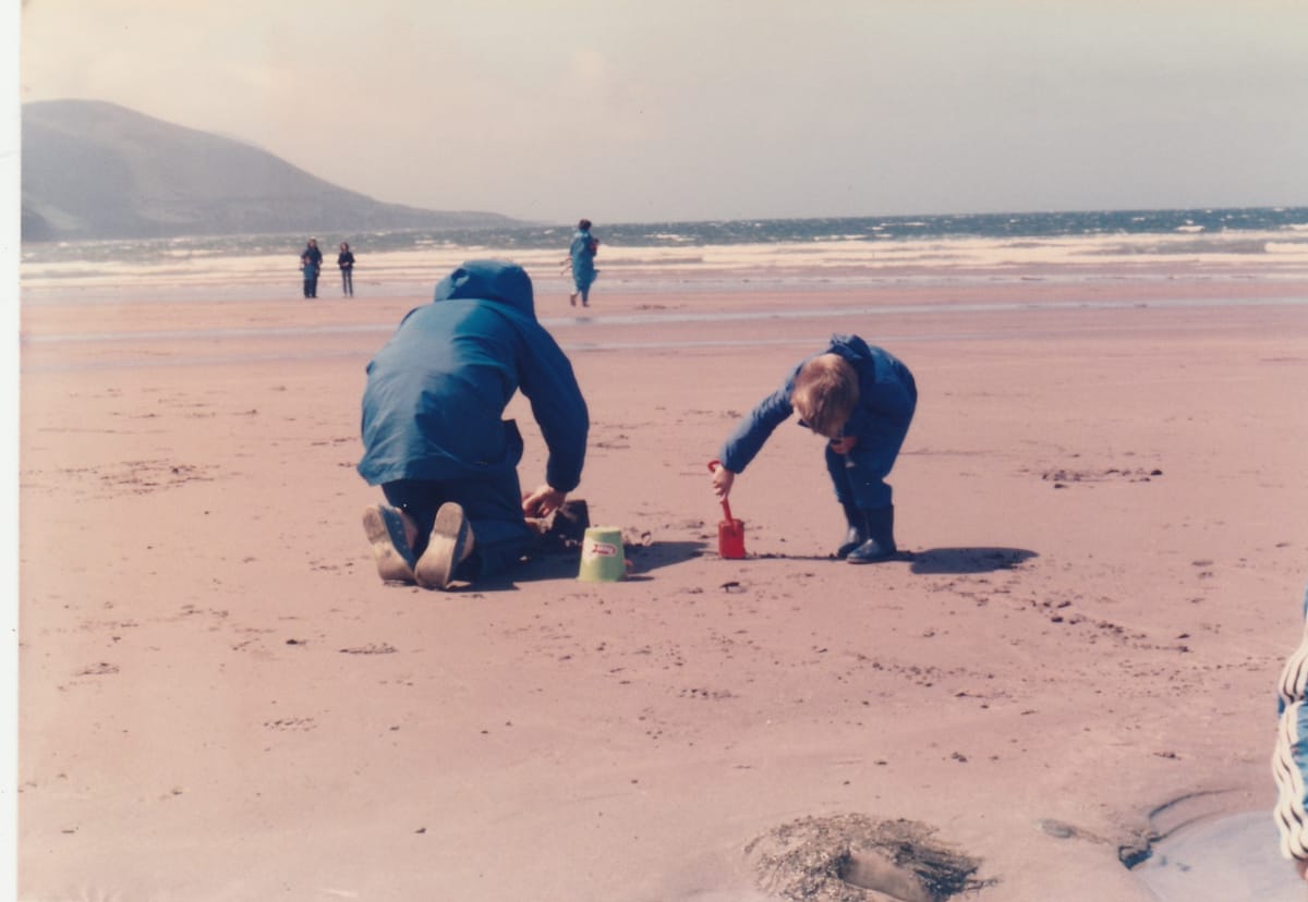 Children making sandcastles on a beach in Ireland