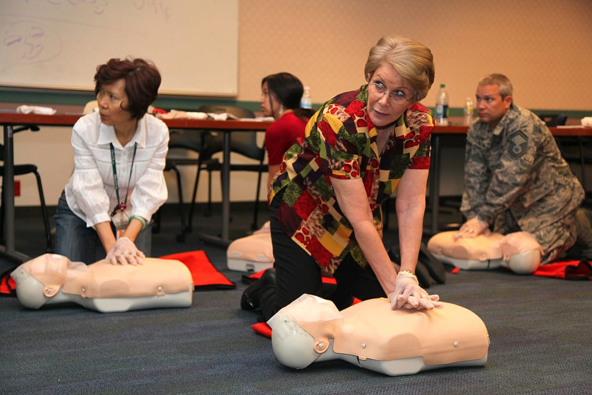 People practising CPR on training mannequins